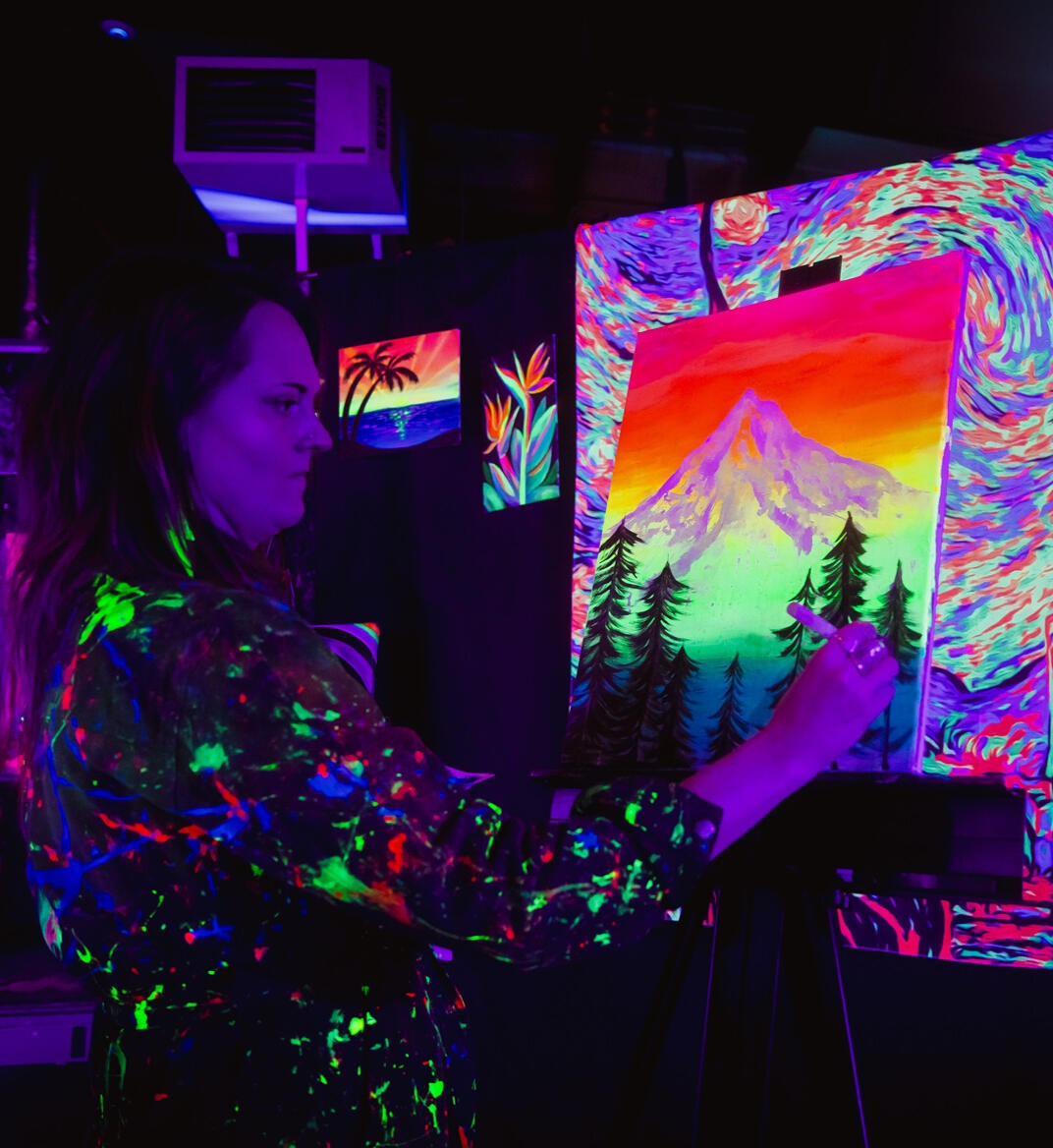 Kindra teaching how to paint a mountain